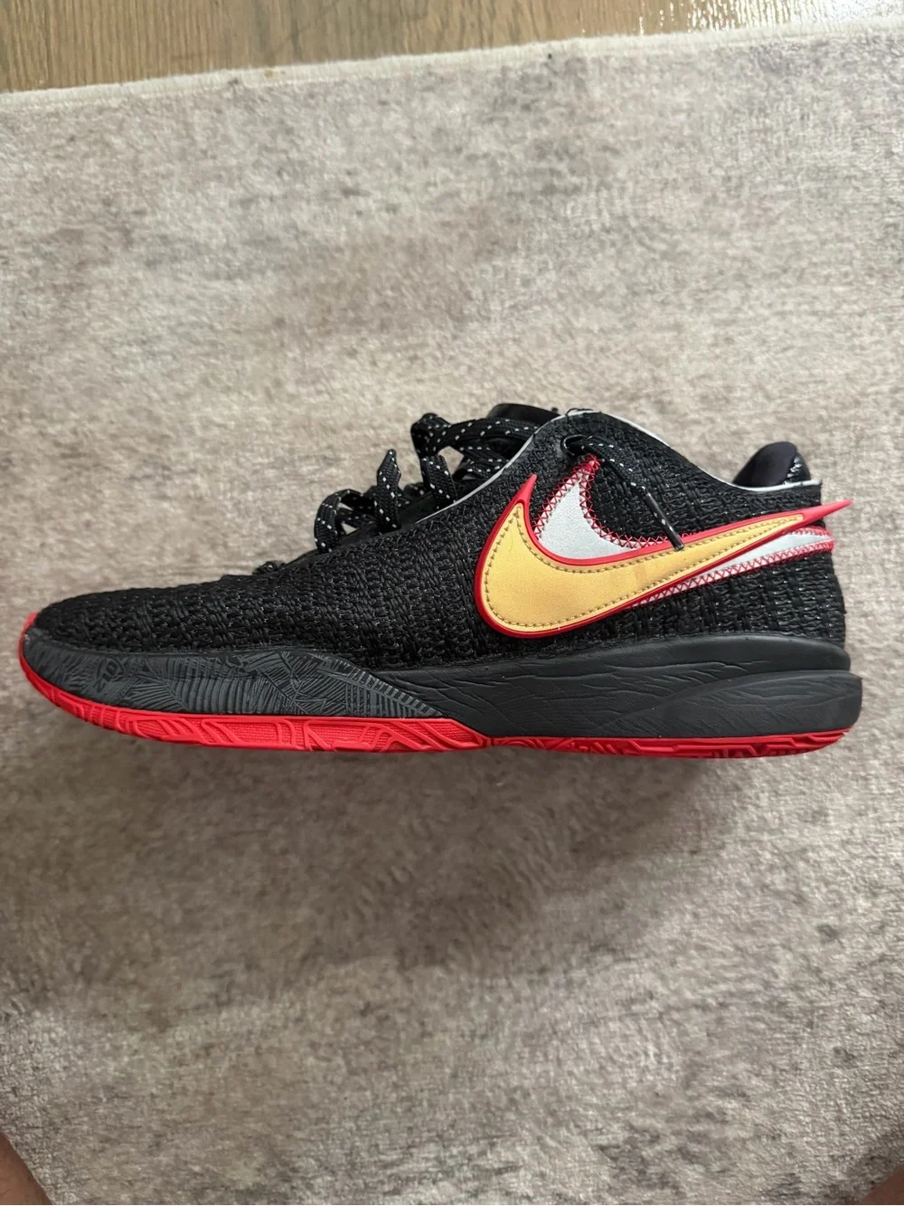 Nike LeBron 21… Men’s Black Knit Sneaker with Red Outsole and Gold Swoosh